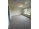 Well-lit bedroom boasts plush carpeting, a window with views, and neutral decor for a cozy feel at 23 Quail Pt Cir, Clayton, NC 27520