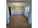 Bright dining room with hardwood floors, trim, chandelier, and natural light at 23 Quail Pt Cir, Clayton, NC 27520