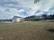 A shot of the back exterior of the two-story home showing the yard at 23 Quail Pt Cir, Clayton, NC 27520