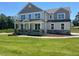 Charming two-story home with a manicured lawn and classic architectural details at 23 Quail Pt Cir, Clayton, NC 27520