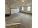 Spacious garage with concrete floor, automatic door, and natural light from two windows at 23 Quail Pt Cir, Clayton, NC 27520