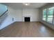 Spacious living room features hardwood floors, a fireplace, and large windows at 23 Quail Pt Cir, Clayton, NC 27520