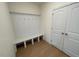 This mudroom boasts a built-in bench with coat hooks and a closet for organized storage at 23 Quail Pt Cir, Clayton, NC 27520
