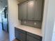 A gray pantry with light countertops provides excellent storage for the kitchen at 23 Quail Pt Cir, Clayton, NC 27520