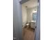This powder room features a modern vanity, hardwood floors, and crisp white walls at 23 Quail Pt Cir, Clayton, NC 27520
