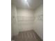 A practical walk-in closet equipped with sturdy wire shelving for efficient storage solutions at 23 Quail Pt Cir, Clayton, NC 27520