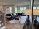 Open-concept living room with a large sectional sofa, a neutral rug, and lots of natural light at 230 Grading Stick Ct, Angier, NC 27501