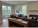 Cozy living room featuring a fireplace, sectional sofa, and adjacent dining area, creating an inviting living space at 230 Grading Stick Ct, Angier, NC 27501