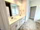 Double sink vanity featuring bronze hardware and decorative flooring at 328 Bishop Lane, Sanford, NC 27330