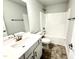 Well-lit bathroom featuring a single vanity, tub, and modern fixtures at 328 Bishop Lane, Sanford, NC 27330