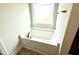 Soaking tub with bronze fixtures and decorative flooring at 328 Bishop Lane, Sanford, NC 27330