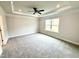 Spacious bedroom featuring a tray ceiling with recessed lighting, ceiling fan and a large window at 328 Bishop Lane, Sanford, NC 27330