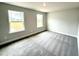 A carpeted bedroom featuring two bright windows that allow lots of natural light to enter the space at 328 Bishop Lane, Sanford, NC 27330