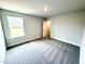 A bright bedroom with two windows and carpeted floor, ready to become a relaxing space with natural light at 328 Bishop Lane, Sanford, NC 27330
