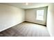 A cozy, carpeted bedroom featuring a window and neutral walls, perfect for relaxation and personalization at 328 Bishop Lane, Sanford, NC 27330