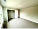 Bright, carpeted bedroom with an open closet and neutral paint, providing a calm and inviting atmosphere at 328 Bishop Lane, Sanford, NC 27330