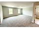Expansive bonus room showcasing plush carpeting, abundant natural light, and versatile open space at 328 Bishop Lane, Sanford, NC 27330