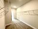 View into a large walk-in closet with metal shelving and gray carpeting at 328 Bishop Lane, Sanford, NC 27330