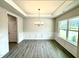 Elegant dining room featuring wainscoting, tray ceiling, and natural light from large windows at 328 Bishop Lane, Sanford, NC 27330