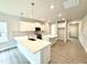 Modern kitchen with stainless steel appliances, quartz countertops, and a spacious island at 328 Bishop Lane, Sanford, NC 27330
