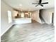 Open-concept living space with kitchen view, featuring a ceiling fan and natural light at 328 Bishop Lane, Sanford, NC 27330