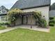 Inviting front entrance featuring a charming pergola covered in flowering vines, enhancing the home's curb appeal at 3700 Lark Farm Rd, Franklinton, NC 27525