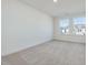 Well-lit bedroom with two windows and carpeted floor at 40 Lavender Ln, Clayton, NC 27520