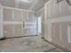 Unfinished garage with concrete floor and doorway access at 40 Lavender Ln, Clayton, NC 27520