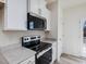 Modern kitchen with white cabinets, stainless steel appliances and quartz countertops at 40 Lavender Ln, Clayton, NC 27520