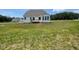 The home's backyard features a small deck and lush green space at 52 Quail Point Cir, Clayton, NC 27520