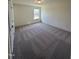 Bedroom with plush carpet, neutral walls, and a window at 52 Quail Point Cir, Clayton, NC 27520
