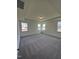 Large bedroom featuring plush carpet, neutral walls, and multiple windows at 52 Quail Point Cir, Clayton, NC 27520