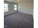 Bedroom with plush carpet, neutral walls, and two windows at 52 Quail Point Cir, Clayton, NC 27520