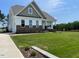Inviting two-story home with brick accents and a lush green lawn, showcasing quality construction and design at 52 Quail Point Cir, Clayton, NC 27520