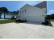 Side view of a two-story home featuring white siding and an attached two-car garage at 52 Quail Point Cir, Clayton, NC 27520