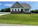 Charming home featuring inviting curb appeal with lush greenery and a well-maintained lawn at 52 Quail Point Cir, Clayton, NC 27520