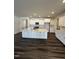 Spacious kitchen features a large island with white cabinetry, stainless appliances and tile backsplash at 52 Quail Point Cir, Clayton, NC 27520
