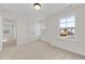 Bright bedroom with carpet, window, and door to hallway at 1019 Gibson House Dr, Burlington, NC 27215