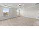 Well-lit bedroom with carpet flooring and large windows offering an outdoor view at 1019 Gibson House Dr, Burlington, NC 27215