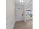 Elegant entryway with hardwood floors, white wainscoting and a front door at 1019 Gibson House Dr, Burlington, NC 27215