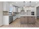 Modern kitchen boasts white cabinets, quartz countertops, and a farmhouse sink at 1019 Gibson House Dr, Burlington, NC 27215