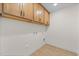 Laundry room with wood cabinets and vinyl flooring at 1019 Gibson House Dr, Burlington, NC 27215