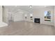 Bright living room features hardwood floors, fireplace, and large windows at 1019 Gibson House Dr, Burlington, NC 27215