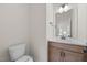 Powder room with wood vanity, white countertop and mirror at 1019 Gibson House Dr, Burlington, NC 27215