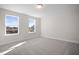 Well-lit bedroom with two large windows and carpet at 1078 Gibson House Dr, Burlington, NC 27215