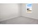 Bright bedroom featuring a large window and grey carpet at 1078 Gibson House Dr, Burlington, NC 27215