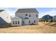 Rear view of the house showcasing a sunroom and a large backyard at 1078 Gibson House Dr, Burlington, NC 27215