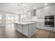 Modern kitchen with white cabinets, a large island, and stainless steel appliances at 1078 Gibson House Dr, Burlington, NC 27215