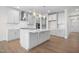 Bright kitchen featuring white cabinets, a center island, and stylish light fixtures at 1078 Gibson House Dr, Burlington, NC 27215