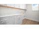 Laundry room with white cabinets and wood flooring at 1078 Gibson House Dr, Burlington, NC 27215